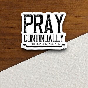 May include: A white sticker with black text that reads "Pray Continually 1 Thessalonians 5:17".