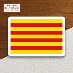 May include: A rectangular sticker featuring a pattern of four horizontal yellow stripes alternating with three horizontal red stripes, all enclosed within a white border. The design is symmetrical and consists of bold, solid blocks of color.