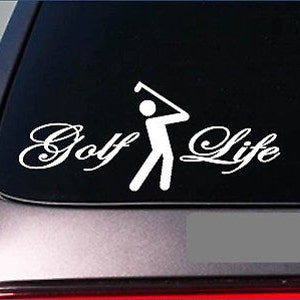 May include: White vinyl decal with the words "Golf Life" in a cursive font, accompanied by a stick figure golfer in mid-swing. The decal is designed to be applied to a car window.