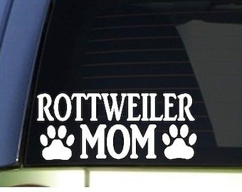 May include: White vinyl decal with the text "Rottweiler Mom" and two paw prints on either side of the word "Mom".