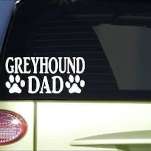 May include: White vinyl decal with the text "Greyhound Dad" and two paw prints on a green car.