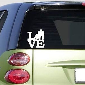 May include: White vinyl decal of a couple holding hands in the shape of the word "LOVE".