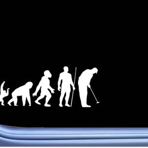 May include: A white vinyl decal of the evolution of man, ending with a golfer putting a golf ball. The decal is on a black background.