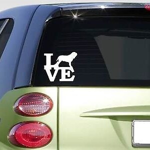 May include: White vinyl decal sticker for a car window. The sticker says "LOVE" with a silhouette of a dog in the "O".