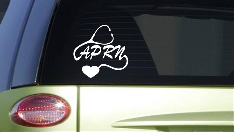 May include: White vinyl sticker with a stethoscope design and the text "APRN" on a car window.