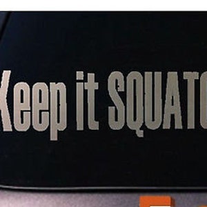 May include: A gray vinyl sticker with the text "Keep it Squatchy!" on a black background.