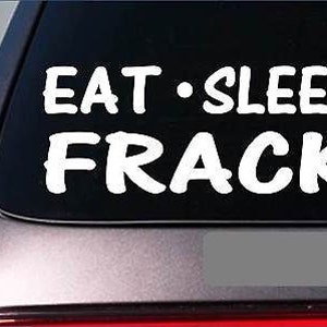 May include: White vinyl decal with the text "Eat - Sleep Frack" on a black background. The decal is applied to the back window of a car.