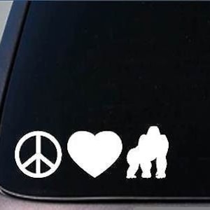 May include: Peace sign, heart, and gorilla silhouette in white on a black background.  This is a vinyl decal sticker.