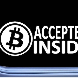 May include: White sticker with a Bitcoin symbol and the text "ACCEPTED INSIDE" on a black background.