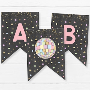 May include: A black and gold banner with pink letters spelling "AB" and a disco ball graphic. The banner is decorated with gold glitter and colorful confetti.