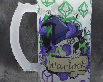 May include: Frosted glass beer mug with a white handle. The mug features a skull wearing a witch hat with purple tentacles and the word "Warlock" on a banner. Green and purple dice shapes decorate the background.