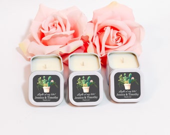 May include: Three square, white metal candles with lids, each featuring a cactus design and the text "Light of my life! Jessica & Timothy Thank you!" Pink roses are in the background. These candles are perfect for gifts.