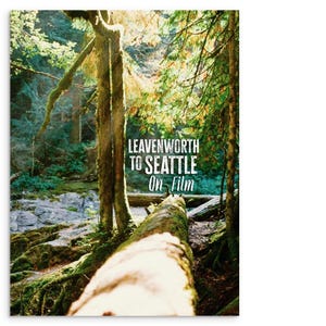 May include: A photograph of a forest scene with a fallen log in the foreground. The image shows vibrant green foliage, moss-covered trees, and the text "LEAVENWORTH TO SEATTLE On Film" in white.