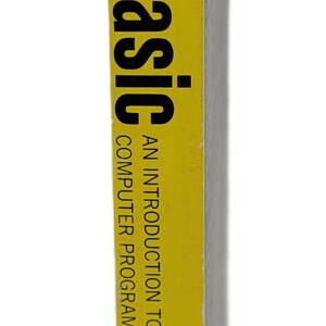May include: A yellow book spine with the title "basic basic" in large black letters. The book is titled "An Introduction to Computer Programming in BASIC Language, Second Edition" by Hayden.