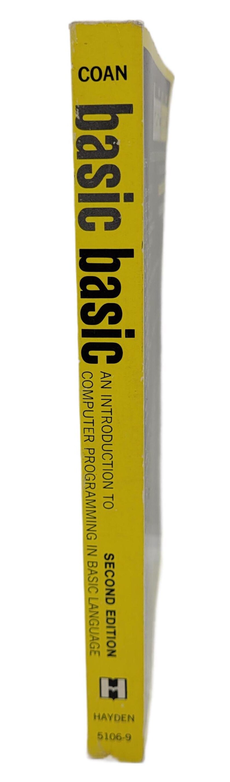 May include: A yellow book spine with the title "basic basic" in large black letters. The book is titled "An Introduction to Computer Programming in BASIC Language, Second Edition" by Hayden.