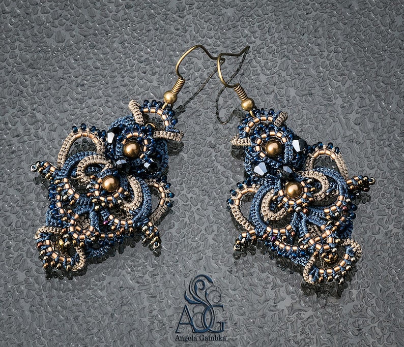May include: A pair of intricate blue and gold earrings with a beaded design. The earrings are made with small beads and have a delicate, feminine look.