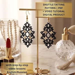 May include: A pair of black shuttle tatting earrings with gold-toned hooks, displayed on a gold metal stand. The text reads: SHUTTLE TATTING PATTERN | PDF + VIDEO TUTORIAL DIGITAL PRODUCT with step-by-step video lessons English/Russian.