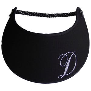 May include: A white ceramic mug with a black handle and the text "But First, Coffee" in a bold, black font. The mug is set against a blurred background, suggesting a cozy setting. The mug appears to be approximately 4 inches tall.