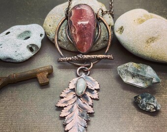 Copper Electroformed Peruvian Rhodochrosite accented with a natural Fern Leaf, set with a beautiful Moonstone .. w/a 18” Copper chain