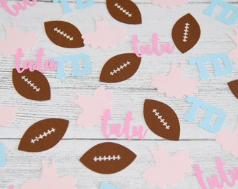 May include: A collection of confetti featuring footballs, tutus, and the letters "TD" in pink, blue, and brown.