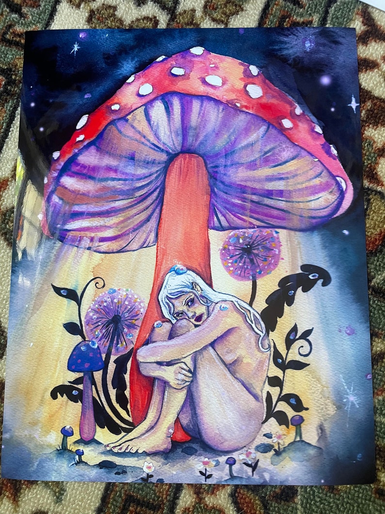 May include: A watercolor painting of a woman sitting under a large, purple and red mushroom with white spots. The woman is nude and has long white hair. The background is a dark blue with stars and a yellow glow.