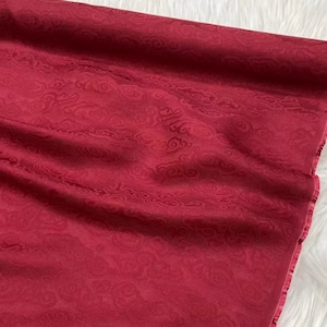 May include: Red fabric with a cloud pattern embossed into the material.