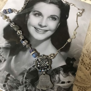 Blue COAT of ARMS bell shaped dog tag vintage assemblage charm necklace blue rhinestone beads upscaled altered art repurposed mixed media
