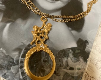 vintage ANGELIC looking glass magnifier goldtone pendant necklace