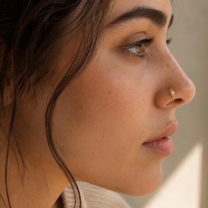A close-up of a woman's face, focusing on her nose and cheek area.