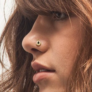 A close-up of a person's face, focusing on their nose and facial features.