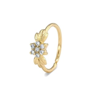Flower Diamond Nose Ring: A gold ring with a flower-shaped gemstone set in the center.