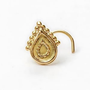 Indian Style Nose Stud: A gold-colored nose stud with a decorative design on the front.