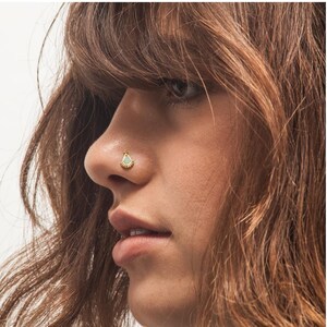 A close-up of a woman's face, focusing on her nose and facial features.