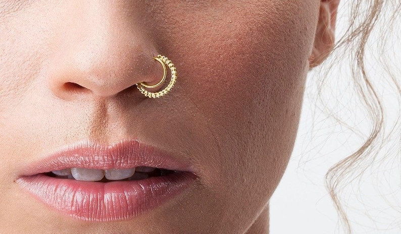 Nose Ring Indian Style Dainty Hoop: A close-up of a person's face, focusing on their nose and lips.