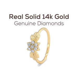a gold ring with a flower-shaped gemstone set in the center.