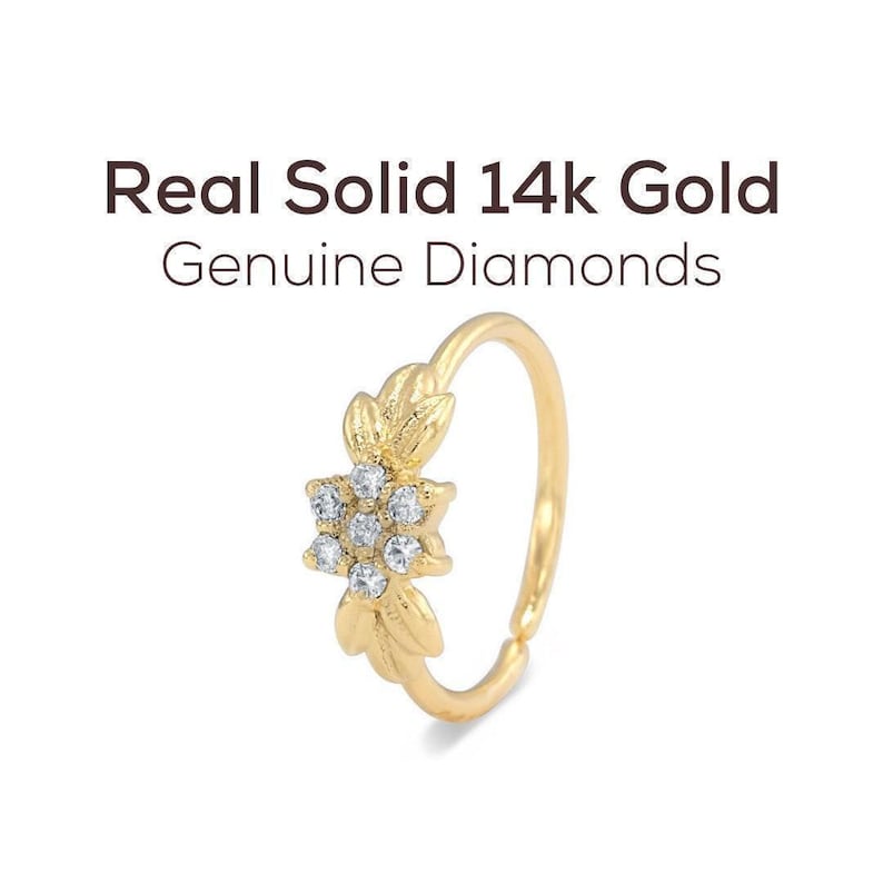 a gold ring with a flower-shaped gemstone set in the center.