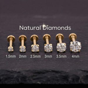 May include: A collection of six gold-colored labret studs with clear, round-cut diamonds. The diamonds range in size from 1.5mm to 4mm. The text "Natural Diamonds" is displayed above the studs.