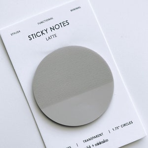 May include: A pack of 50 gray, round, 1.75 inch sticky notes with a transparent finish. The notes are labeled "STICKY NOTES LATTE" and "stylish + minimalco".