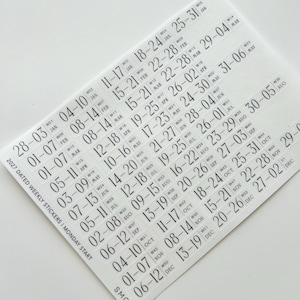 May include: A sheet of clear adhesive stickers featuring black text for the 2027 calendar year. The stickers are organized by week, displaying date ranges, week numbers, and month abbreviations, with a Monday start format and SMCO branding.