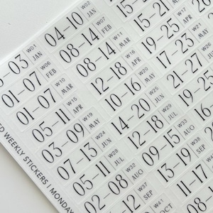 May include: A sheet of clear adhesive weekly stickers featuring black printed text. Each sticker displays a date range, a week number, and a month abbreviation. The text reads WEEKLY STICKERS | MONDAY START, followed by a sequence of dates from January to December.