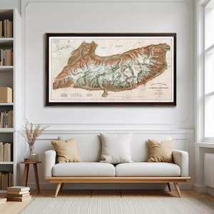 May include: A framed vintage map of a mountainous region, with brown, green, and white hues. The map shows contour lines and text on a cream background. The dark brown frame complements the map's colours. The text reads "Carte Albert-Mercey".