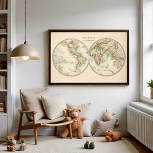 May include: A framed vintage world map print with a black frame, hanging on a white wall. The map shows the world in two hemispheres, with detailed landmasses and countries. The text "THE WORLD HEMISPHERES" is at the top.