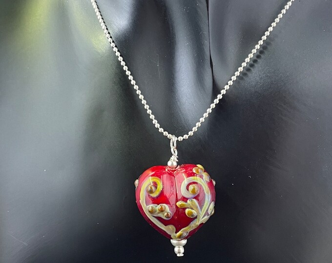 One inch puffy Sangria Red over white glass heart with old fashioned scrollwork