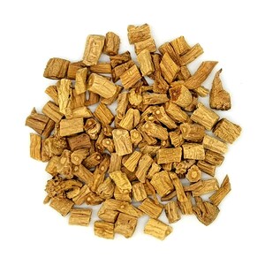 May include: A pile of chopped, dried, tan-colored roots against a white background. The pieces vary in size and shape, with visible textures and natural variations. The overall appearance suggests a natural, unprocessed product.