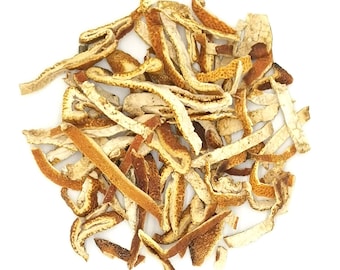 May include: A pile of dried orange peel strips. The pieces are irregular in shape and size, featuring a textured, vibrant orange outer surface and a pale, off-white, spongy inner pith. The strips are curled and twisted, scattered together.