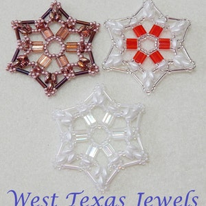 May include: Three beaded snowflake ornaments, one in white, one in red and white, and one in brown and white.