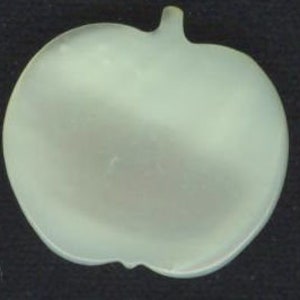 May include: A white iridescent mother of pearl button shaped like an apple.