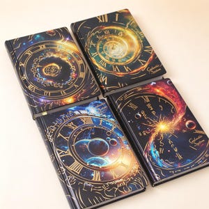 May include: Four rectangular hardcover journals featuring dark space-themed covers with gold Roman numeral clock faces, swirling nebulae, and planetary designs. Each cover displays the text Galactic System in a gold script font on the bottom right.
