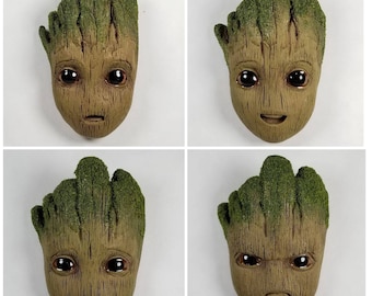 Hand sculpted Baby Groot face fridge magnet.