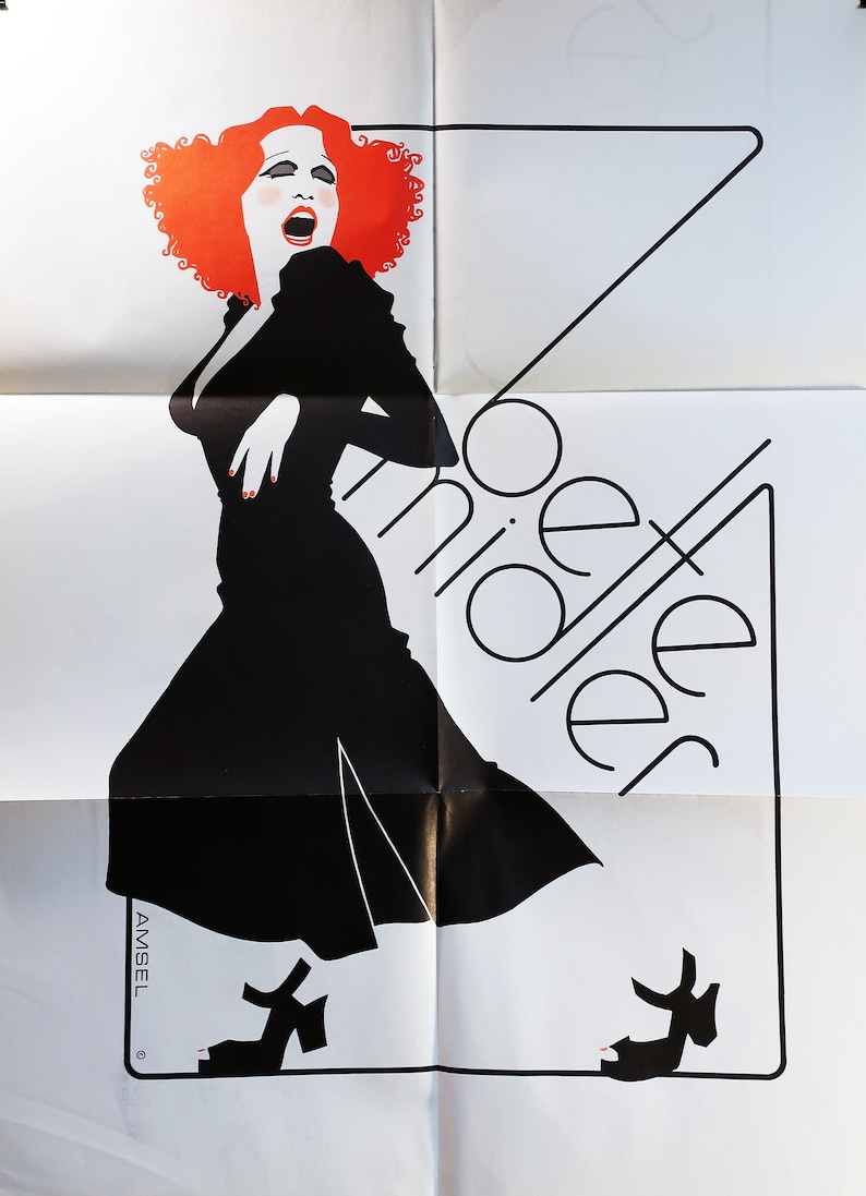 May include: A black and white poster featuring a red-haired woman in a black dress singing. The text "Cabaret" is written in a stylised font.